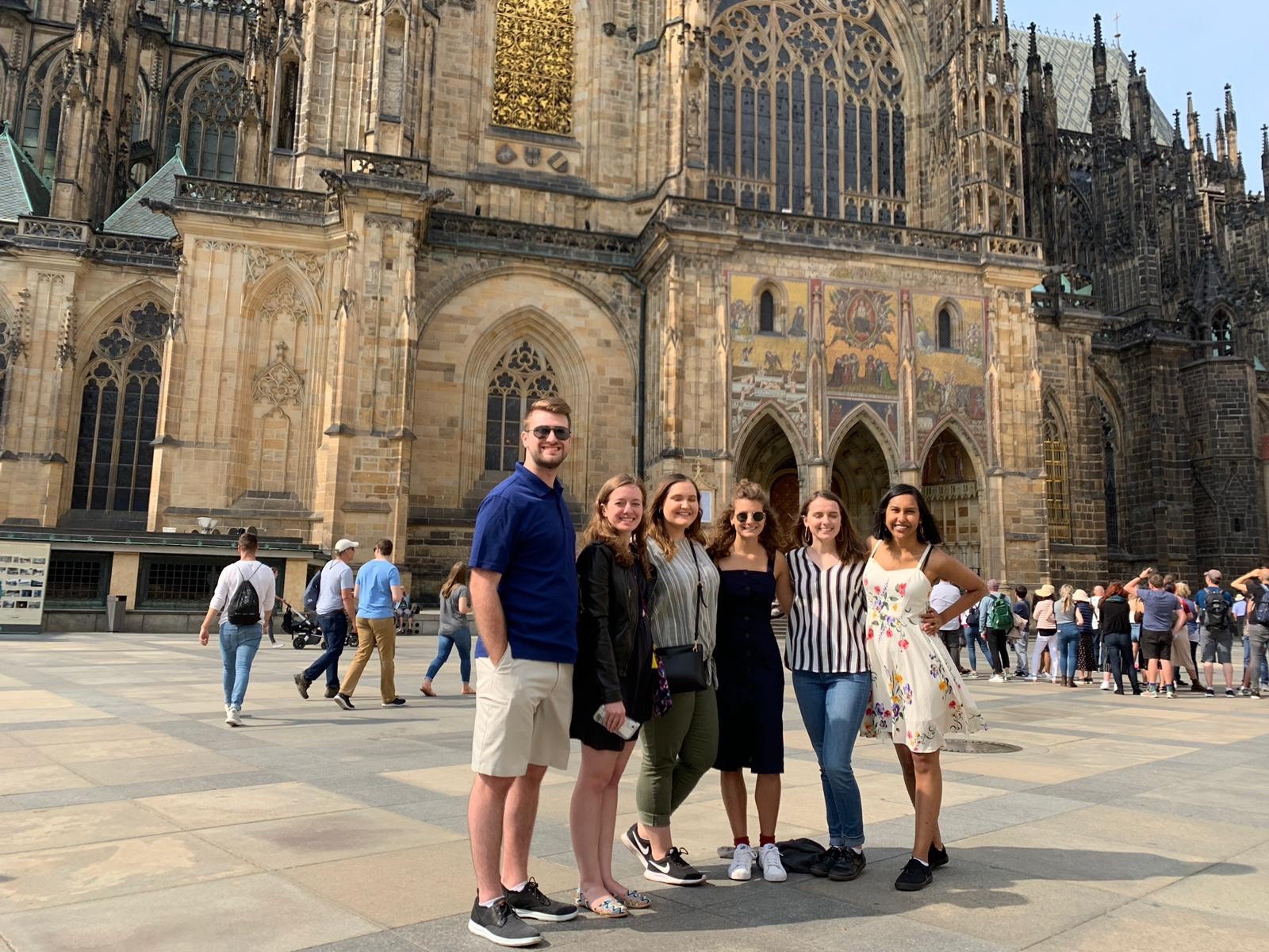 students standing in front of cathedral in prague